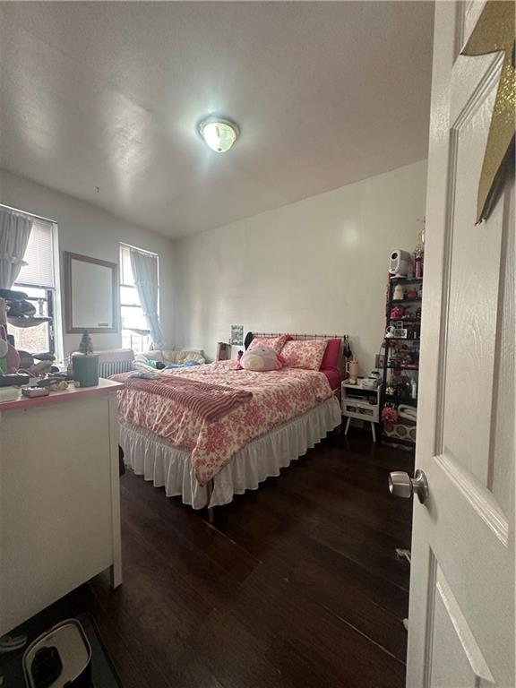 7304 5th Avenue Brooklyn, NY 11209 - Photo 6 of 8 a bedroom with a bed and a window