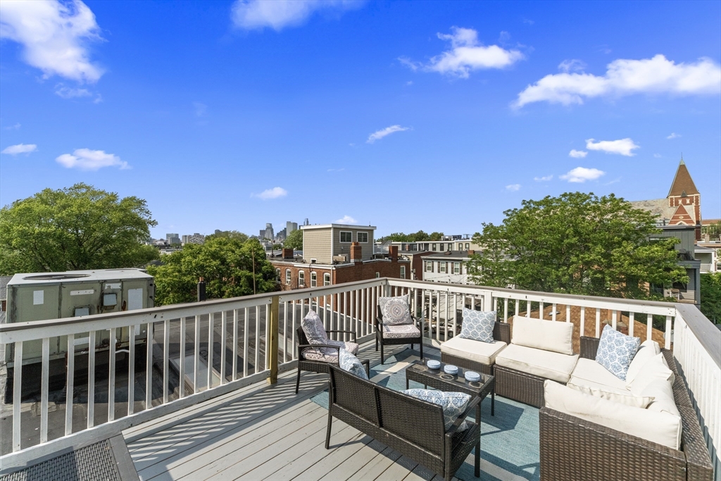 a view of a balcony with wooden benches