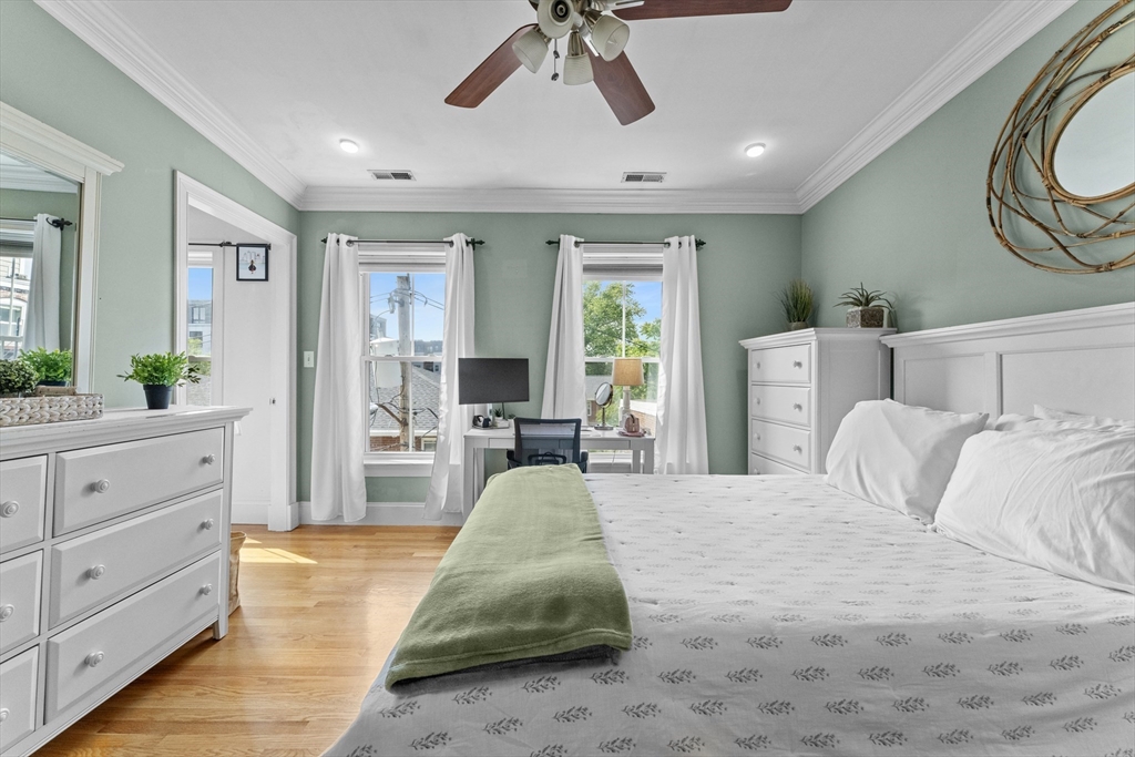 10 Mitchell Street, Unit 3 Boston, MA 02127 - Photo 11 of 15 a spacious bedroom with a large bed and a chandelier