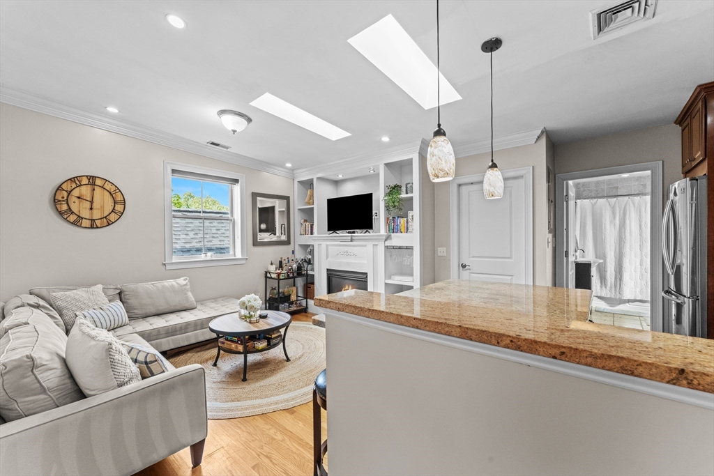 10 Mitchell Street, Unit 3 Boston, MA 02127 - Photo 2 of 15 a living room with fireplace furniture and a flat screen tv