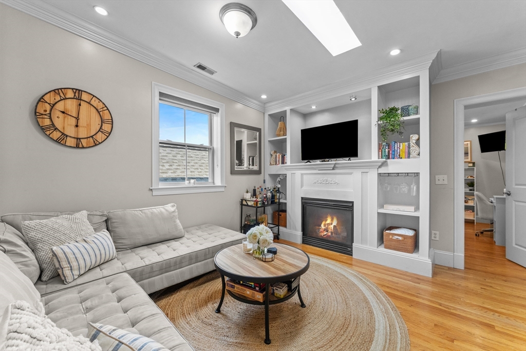 10 Mitchell Street, Unit 3 Boston, MA 02127 - Photo 3 of 15 a living room with furniture a fireplace and a flat screen tv