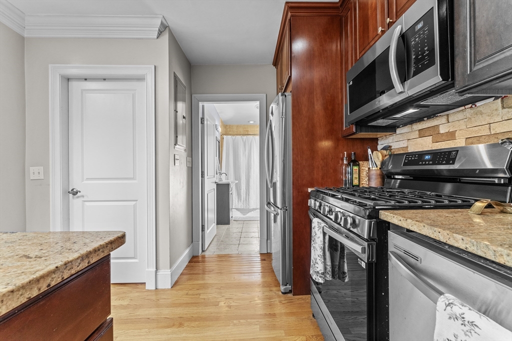 10 Mitchell Street, Unit 3 Boston, MA 02127 - Photo 7 of 15 a kitchen with stainless steel appliances granite countertop a stove and a sink