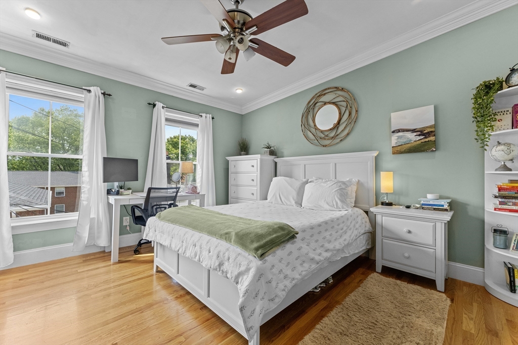 10 Mitchell Street, Unit 3 Boston, MA 02127 - Photo 10 of 15 a bedroom with a bed and a chandelier