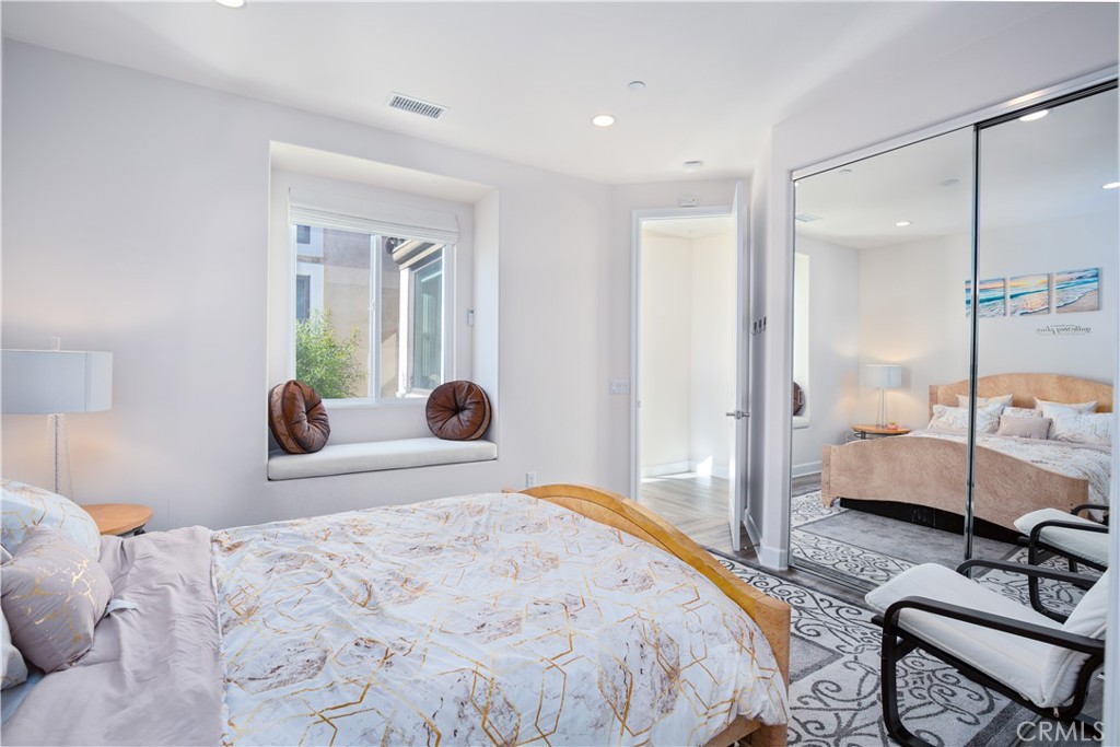 610 17th Street Huntington Beach, CA 92648 - Photo 14 of 64 a bedroom with a bed and wooden floor