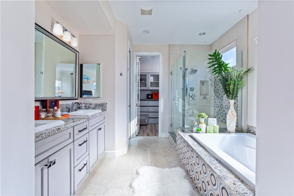 610 17th Street Huntington Beach, CA 92648 - Photo 20 of 64 a bathroom with a tub sink and mirror