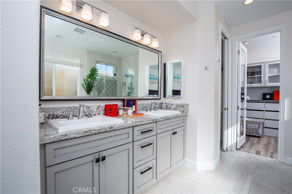 610 17th Street Huntington Beach, CA 92648 - Photo 21 of 64 a bathroom with a granite countertop sink and a mirror