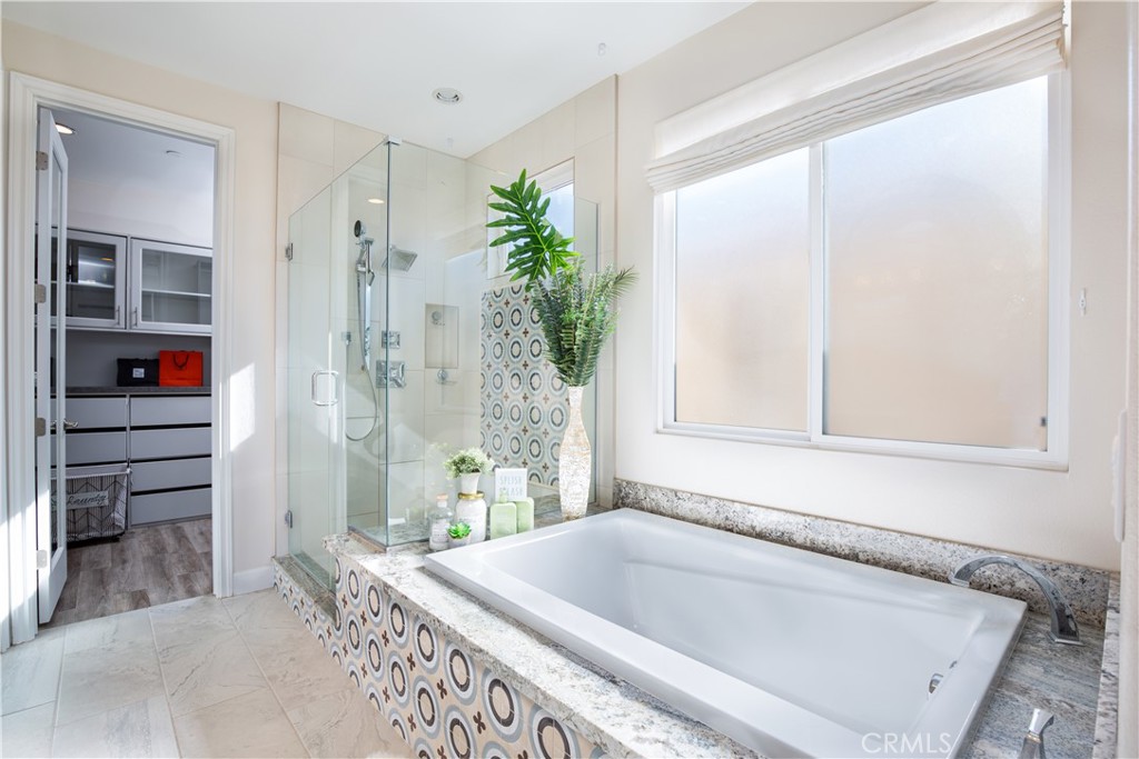 610 17th Street Huntington Beach, CA 92648 - Photo 22 of 64 a bathroom with a tub and shower