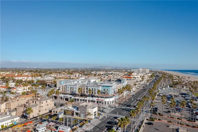 a view of a patio with table and chairs potted plants and a large tree
