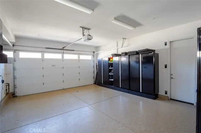 a kitchen with stainless steel appliances white cabinets and wooden floor