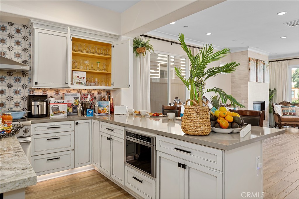 610 17th Street Huntington Beach, CA 92648 - Photo 43 of 64 a kitchen with stainless steel appliances white cabinets and wooden floor