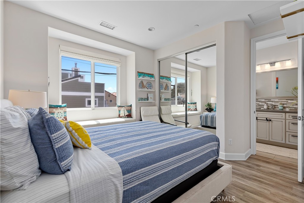 610 17th Street Huntington Beach, CA 92648 - Photo 51 of 64 a bedroom with a bed and wooden floor