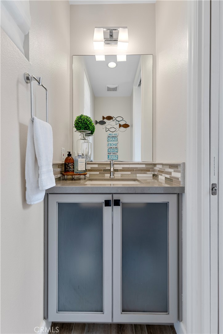 610 17th Street Huntington Beach, CA 92648 - Photo 56 of 64 a bathroom with a sink and a mirror