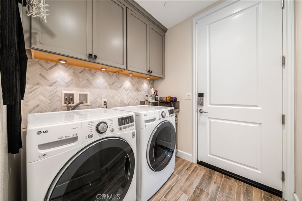 610 17th Street Huntington Beach, CA 92648 - Photo 59 of 64 a view of washer and dryer with kitchen in the background