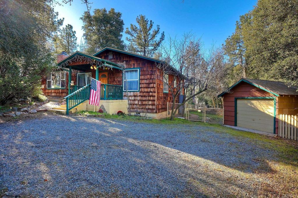 a view of a house with a yard and hanging chair