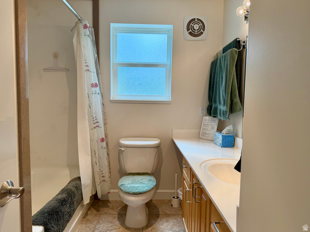 1133 Paris Canyon Road Paris, ID 83261 - Photo 26 of 75 Bathroom featuring a built-in tub with shower, a vanity with a drop-in sink, wood-finish cabinetry, and tiled flooring