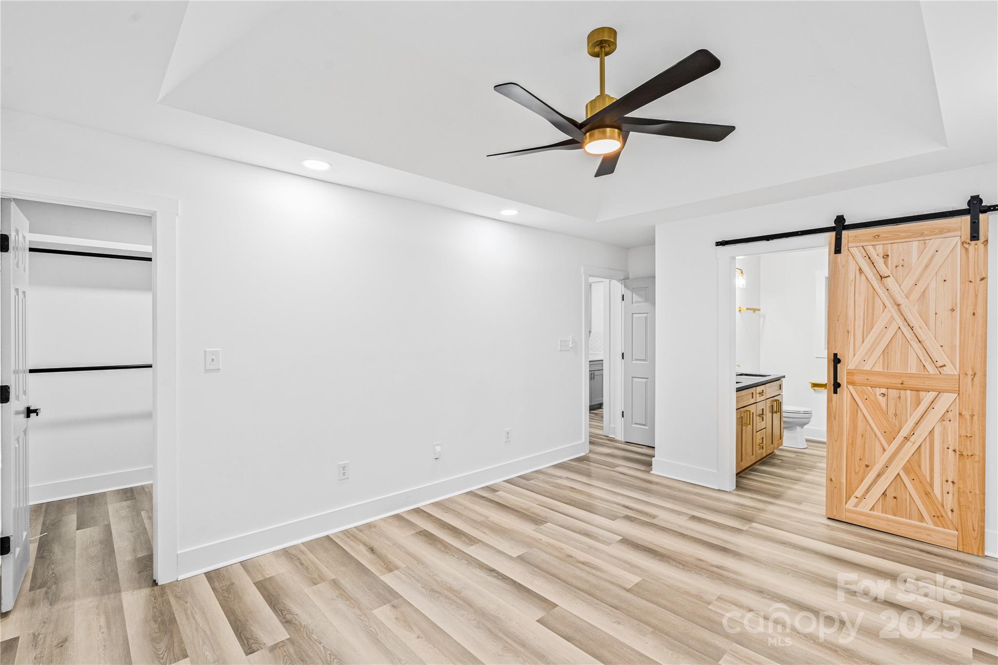 2105 Timber Ridge Road Monroe, NC 28112 - Photo 13 of 27 a view of a room with wooden floor and a ceiling fan