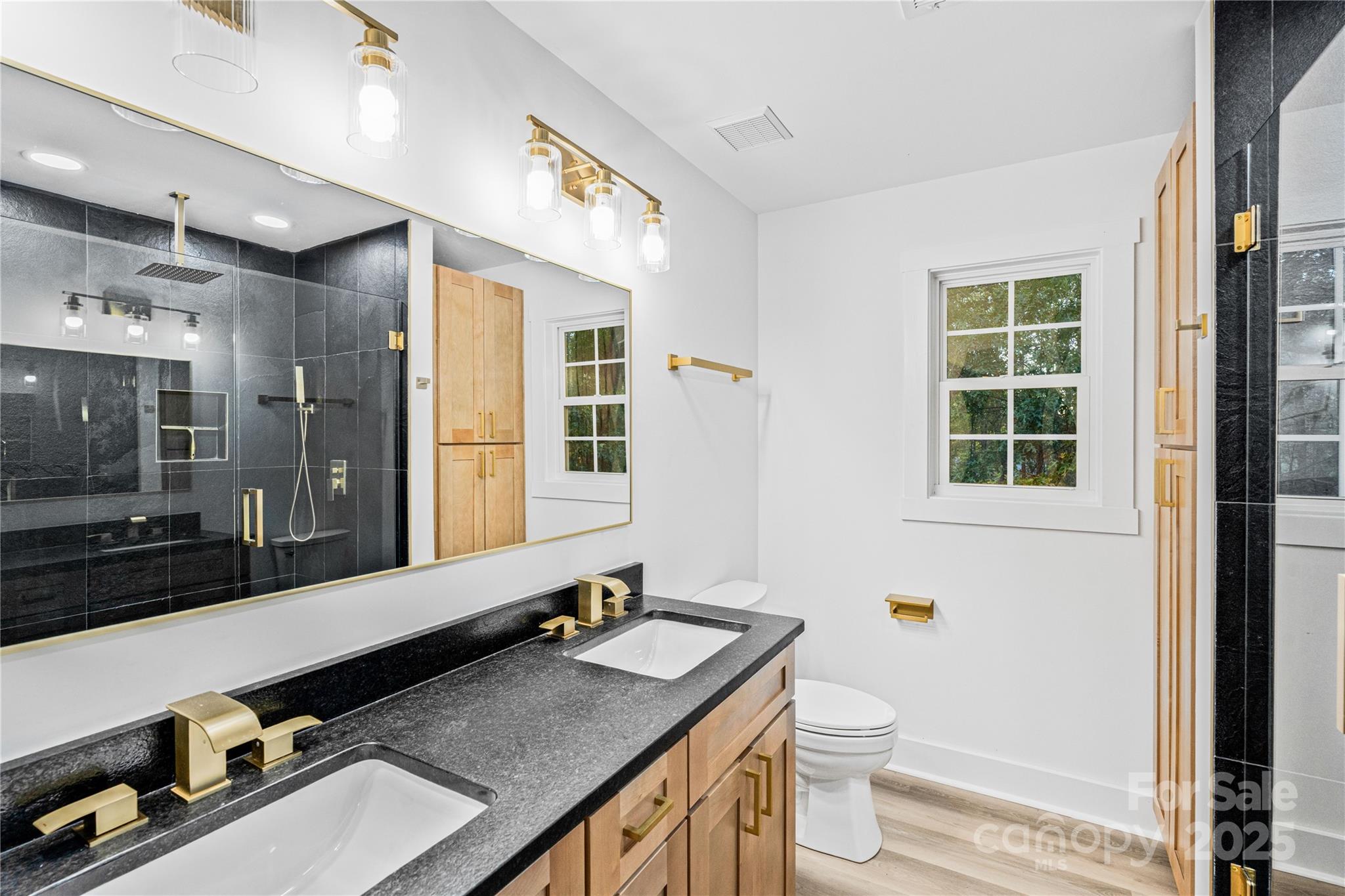 2105 Timber Ridge Road Monroe, NC 28112 - Photo 14 of 27 a bathroom with a granite countertop sink and a large mirror