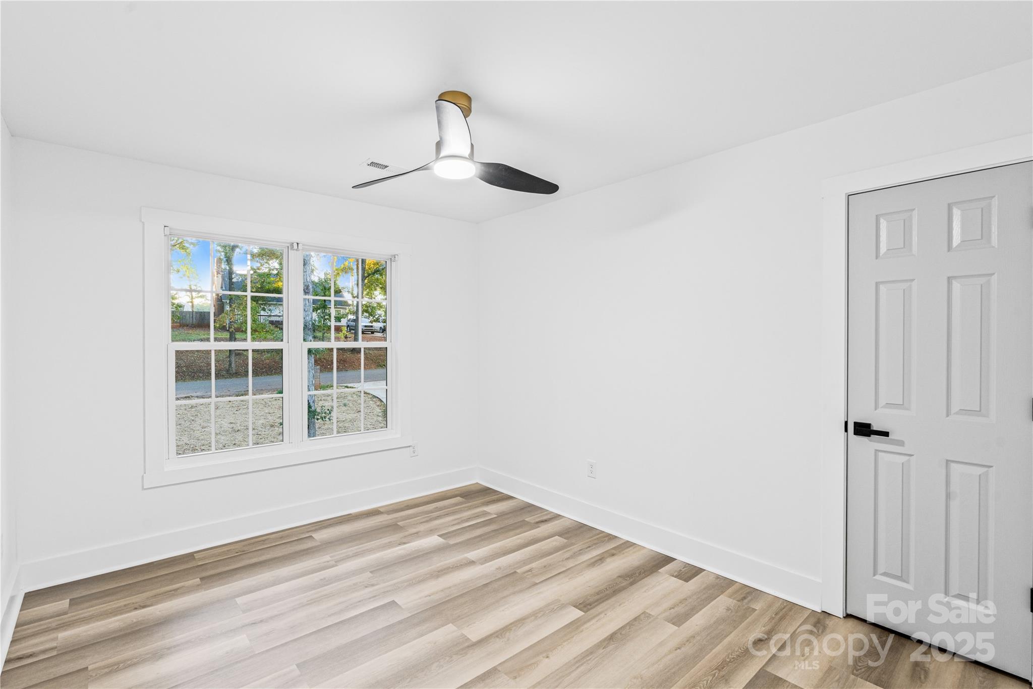 2105 Timber Ridge Road Monroe, NC 28112 - Photo 18 of 27 an empty room with wooden floor and windows