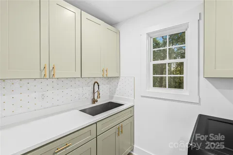 a view of a sink and cabinets