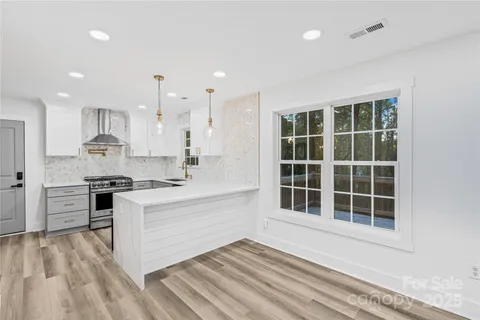 a kitchen with a stove a sink and a refrigerator