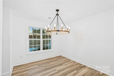 a view of a livingroom with wooden floor and a window