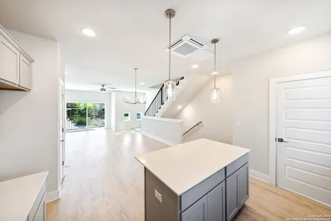 a view of a room with wooden floor and staircase