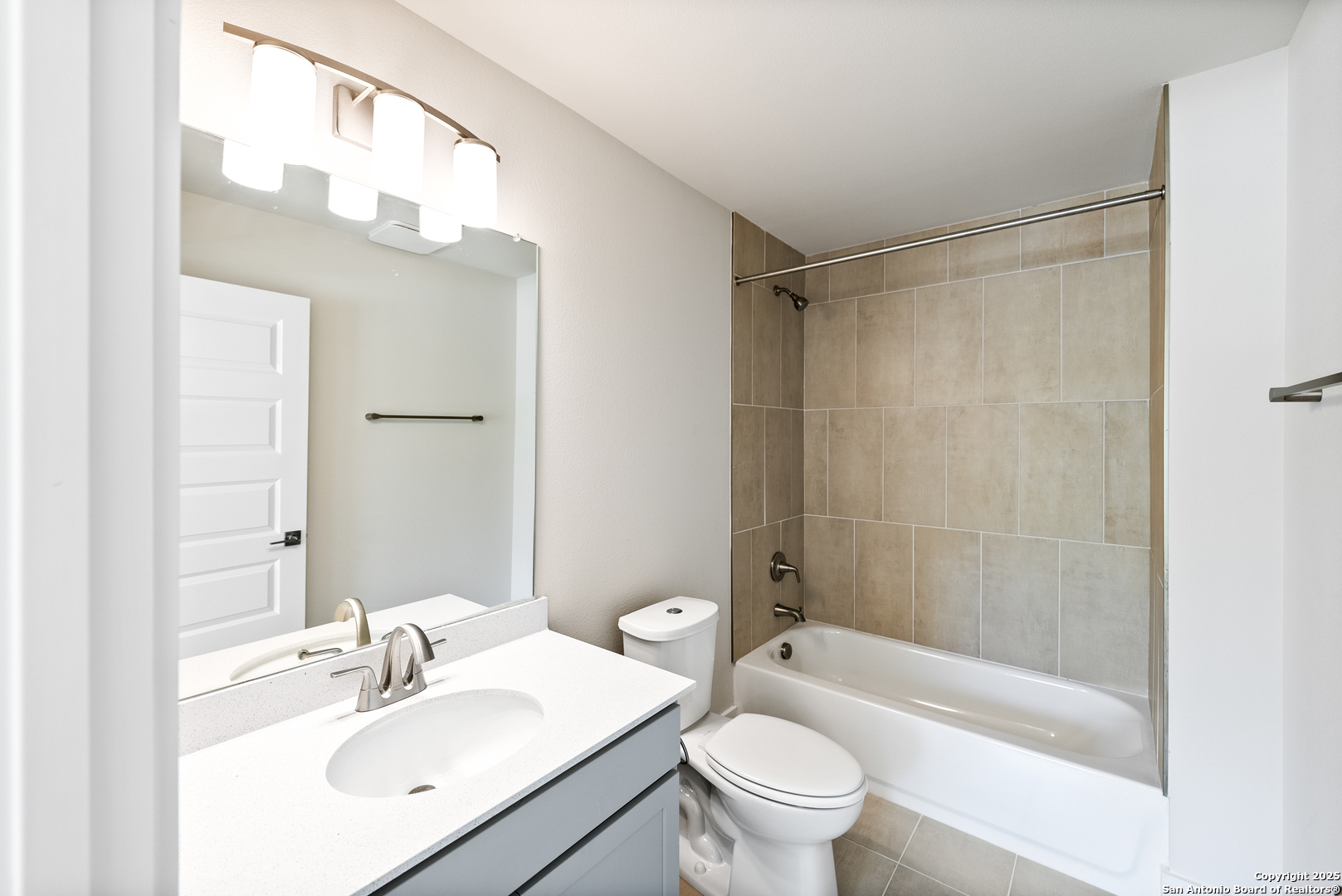 419 Ira Avenue, Unit 1101 San Antonio, TX 78209 - Photo 5 of 22 a bathroom with a sink a toilet a mirror a bathtub and shower