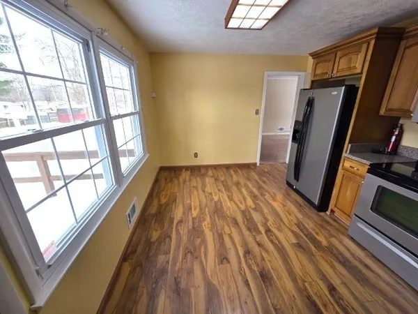 a view of a room with wooden floor and windows