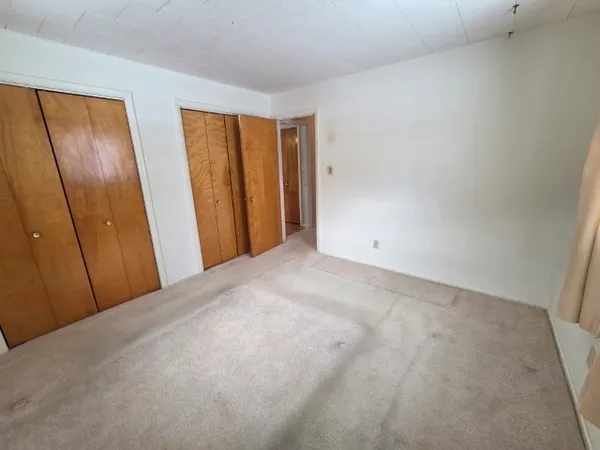 a view of an empty room with yellow walls