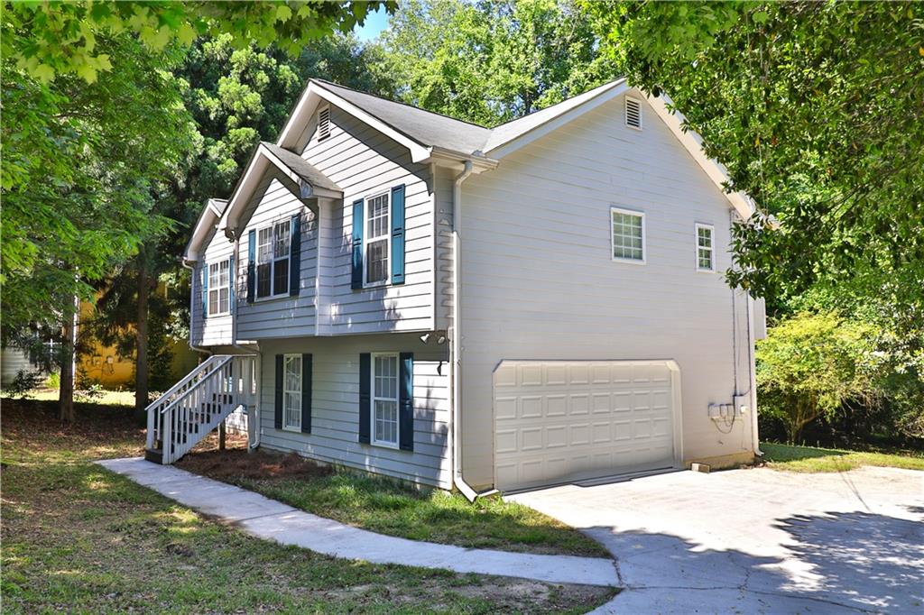 353 Fall View Court Winder, GA 30680 - Photo 5 of 61 a front view of a house with a yard and garage