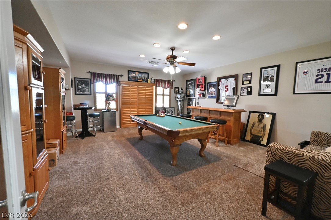 2729 Kildrummie Street Henderson, NV 89044 - Photo 26 of 42 An inviting recreation room with soft carpeting and a ceiling fan promises endless entertainment.