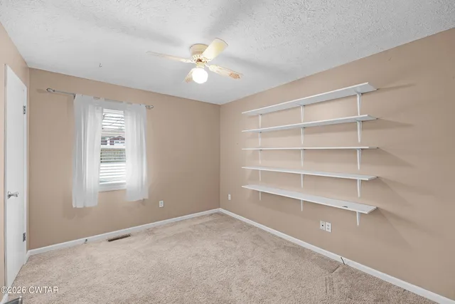 a view of an empty room with windows