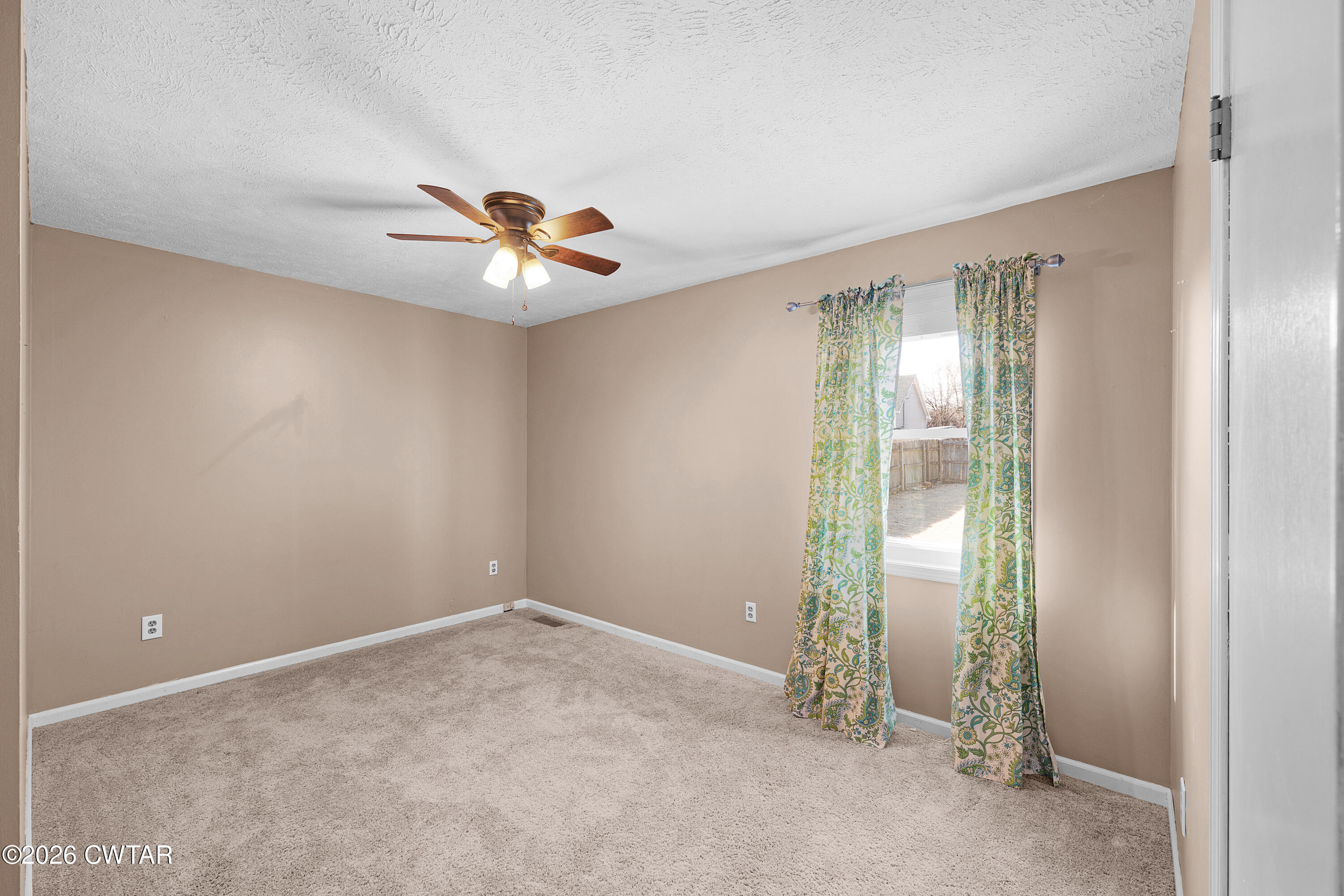 47 Roxy Cove Jackson, TN 38301 - Photo 16 of 18 an empty room with closet and a chandelier fan