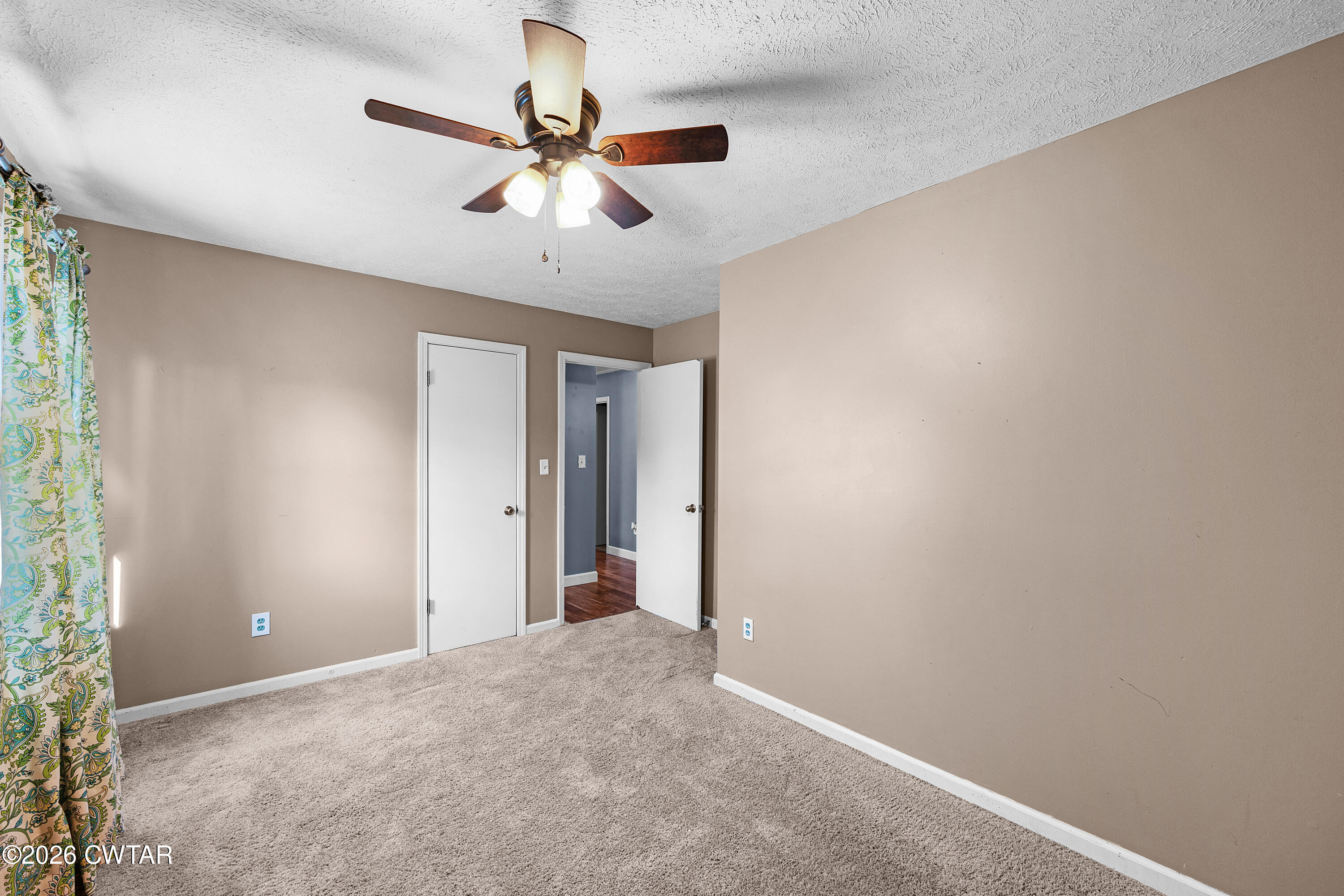 47 Roxy Cove Jackson, TN 38301 - Photo 17 of 18 a view of a livingroom with a ceiling fan and window