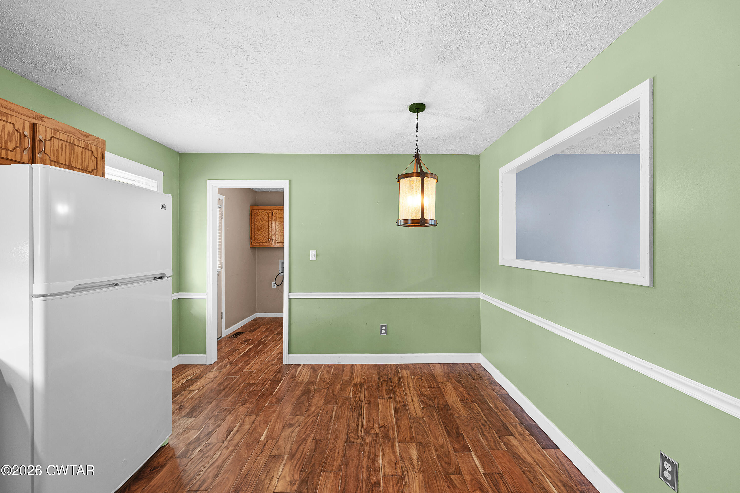 47 Roxy Cove Jackson, TN 38301 - Photo 8 of 18 a view of empty room with wooden floor and window