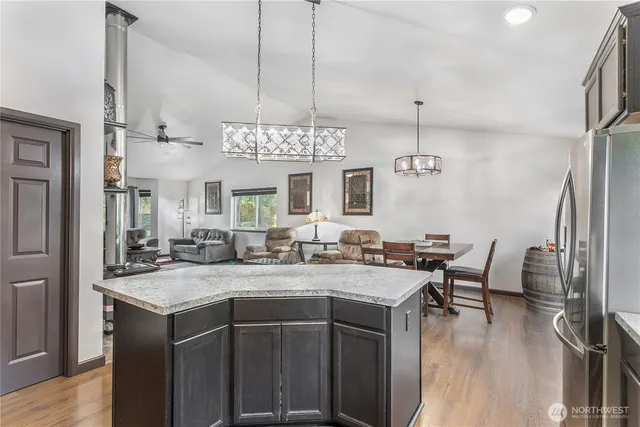 a kitchen with a sink a counter space appliances and cabinets