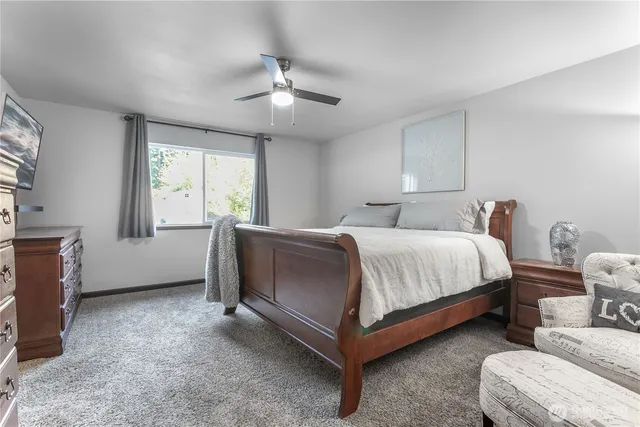 a bedroom with bed and window