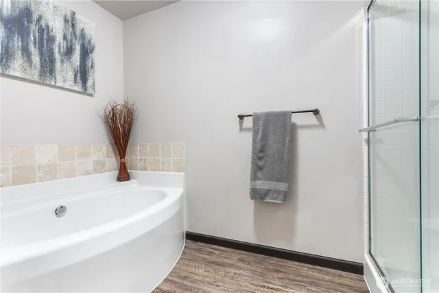 a bathroom with a tub and shower