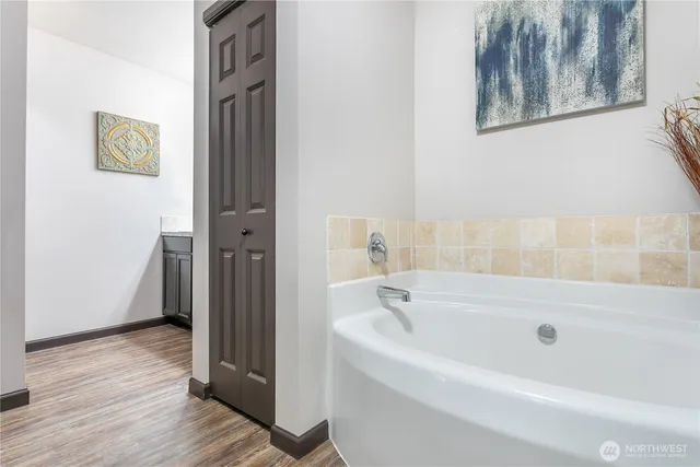 a white bath tub sitting next to a bathroom
