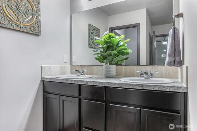 a bathroom with a granite countertop sink and a mirror