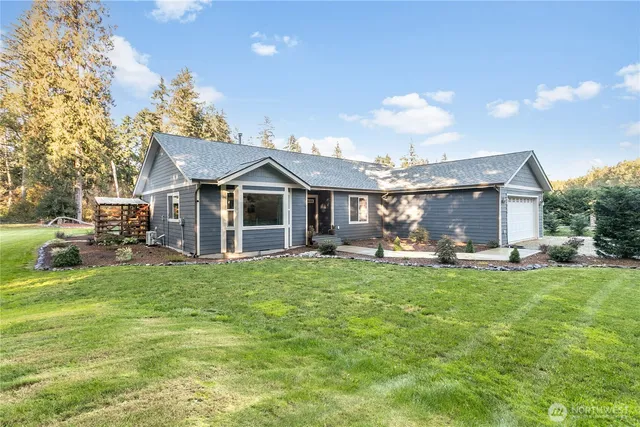 a view of a house with backyard porch and sitting area