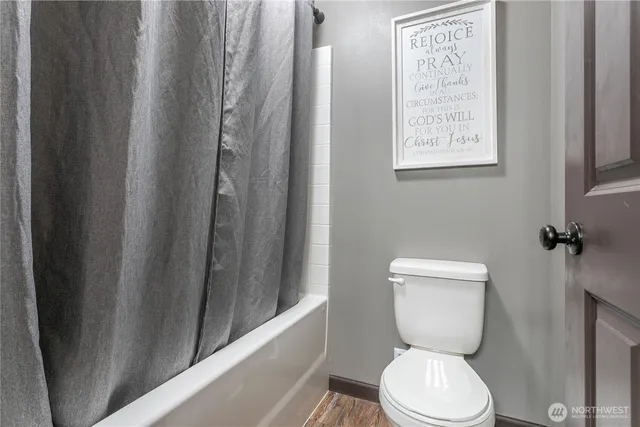 a white toilet sitting next to a small window