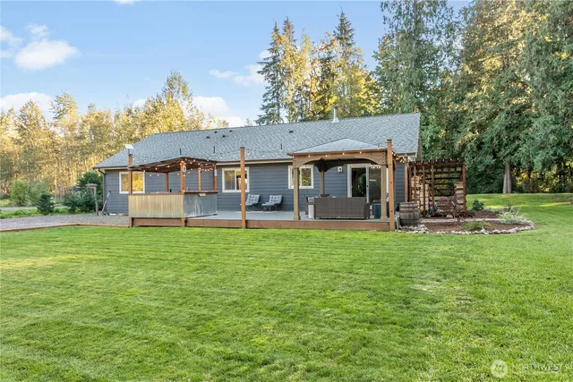 a view of a house with pool and a big yard