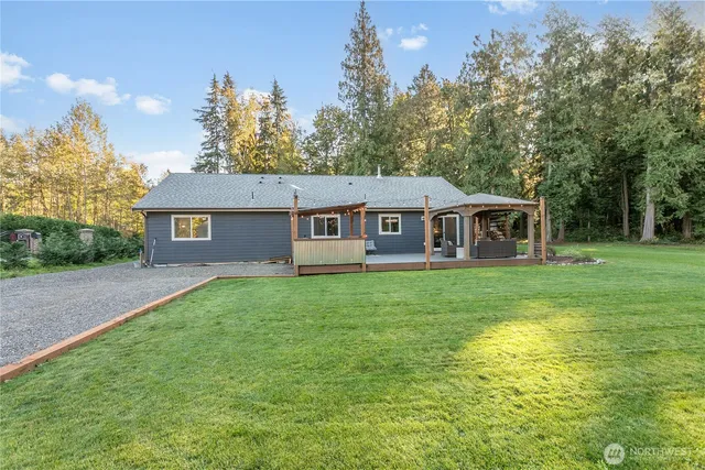 a front view of a house with yard and green space