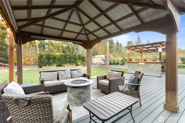a view of a patio with lawn chairs and couches with wooden floor