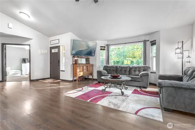 a living room with furniture window and wooden floor