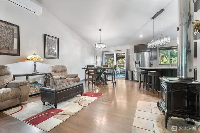 a living room with furniture a dining table and a fireplace