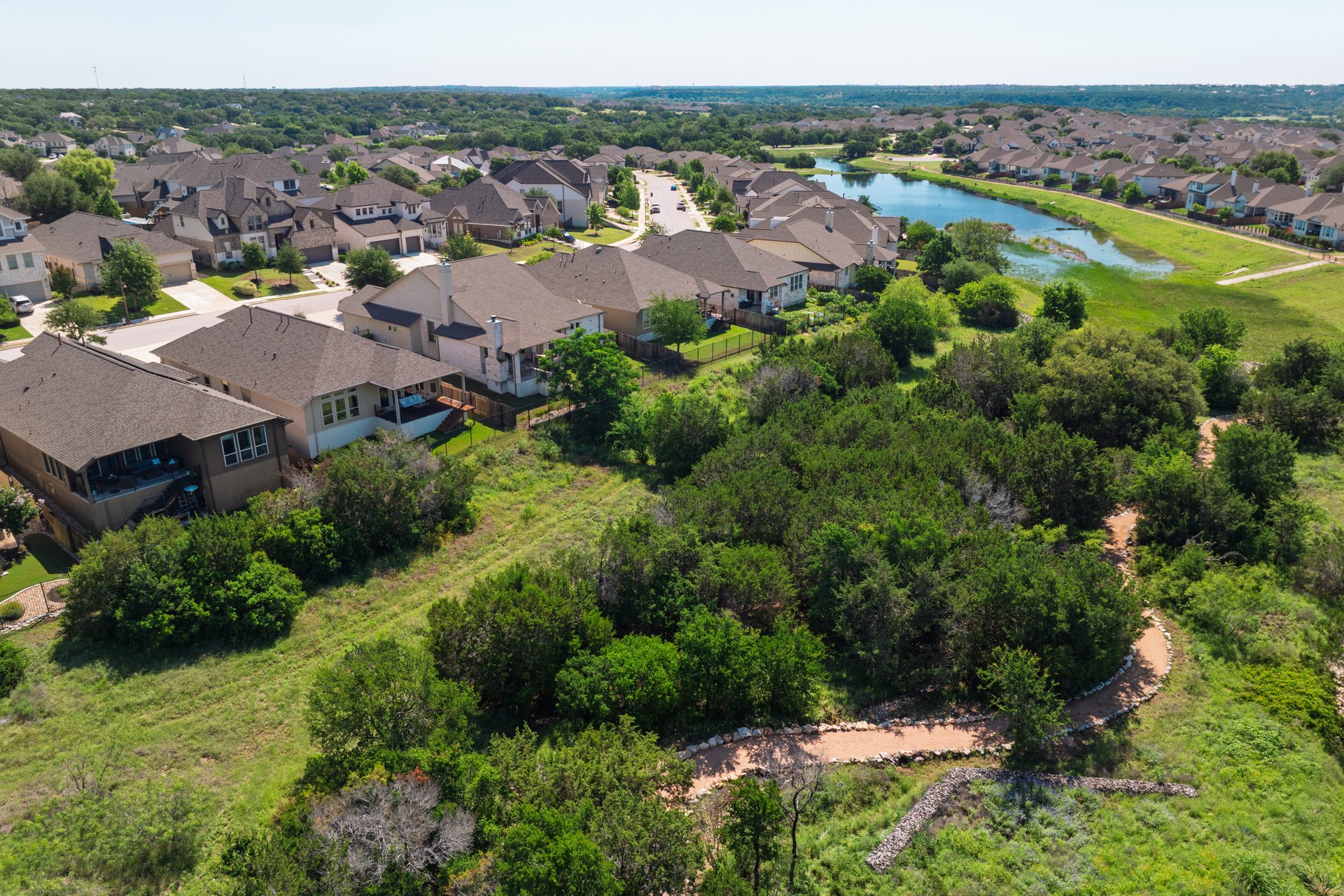 173 Santa Maria Street Georgetown, TX 78628 - Photo 4 of 39 Residential neighborhood featuring an array of homes with various architectural styles, a visible street, and lush green landscaping