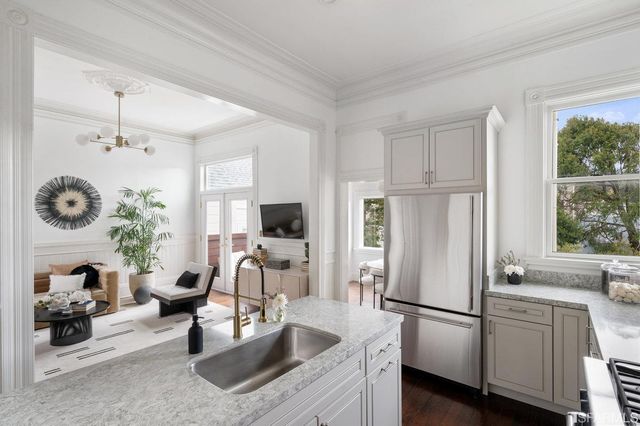 a living room with furniture a flat screen tv and a large window