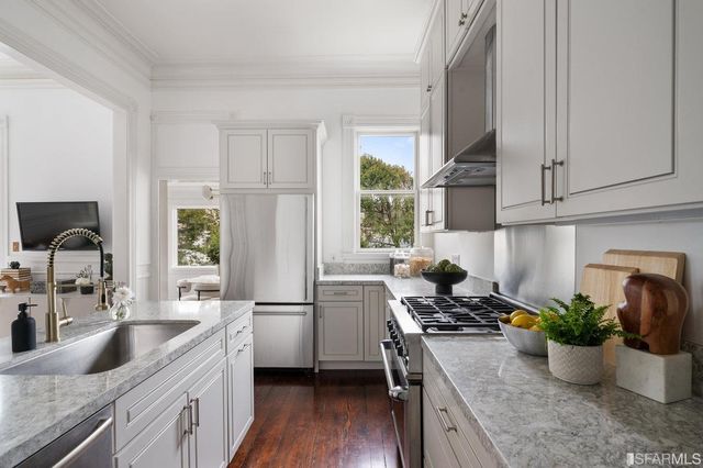 a kitchen with a stove a sink and a refrigerator